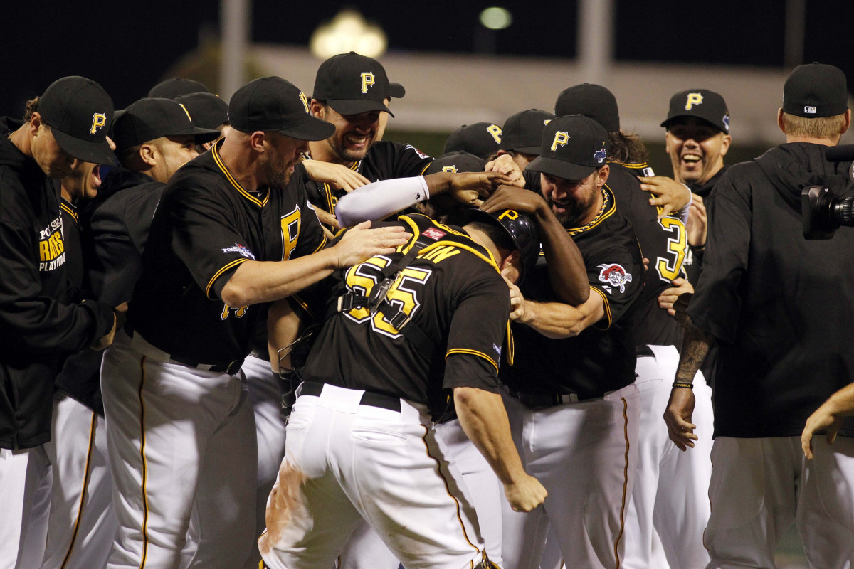 Oct 1, 2013; Pittsburgh, PA, USA; Pittsburgh Pirates catcher Russell Martin (55) is mobbed in celebration by his teammates after defeating the Cincinnati Reds in the National League wild card playoff baseball game at PNC Park. The Pirates won 6-2. Mandatory Credit: Charles LeClaire-USA TODAY Sports ORG XMIT: USATSI-142690 ORIG FILE ID: 20131001_jla_al8_230.jpg
